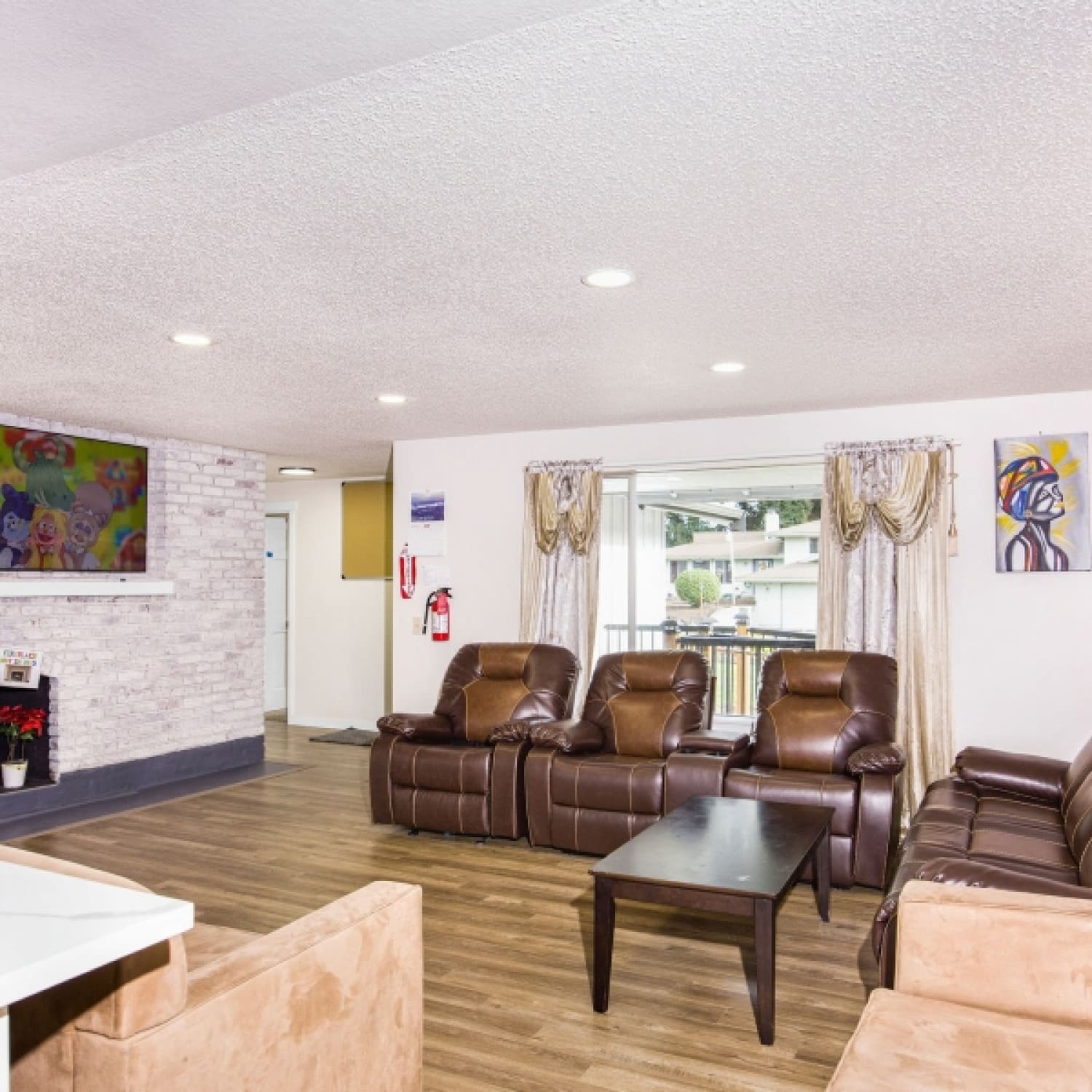 Bright living room with comfortable seating at Loving Garden AFH